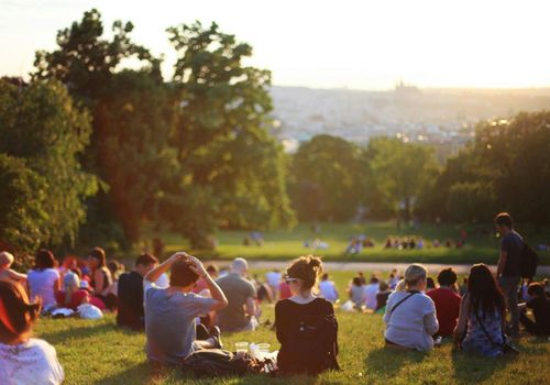 Group of people sitting in a circle on grass