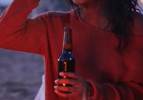 Two people talking and smiling with water bottles